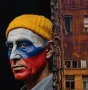 Man with Russian flag face paint and yellow hat beside a crumbling building, symbolizing Romania's political struggles.